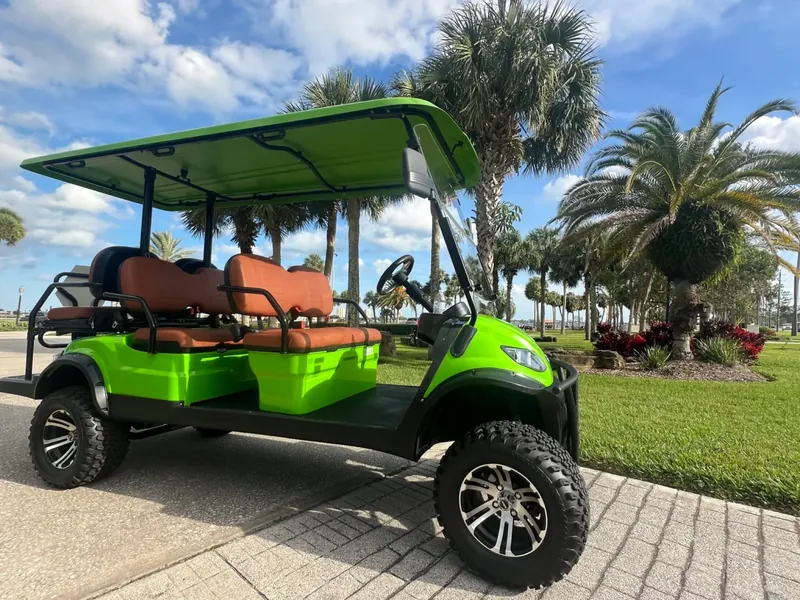 Lime green golf cart under palm trees